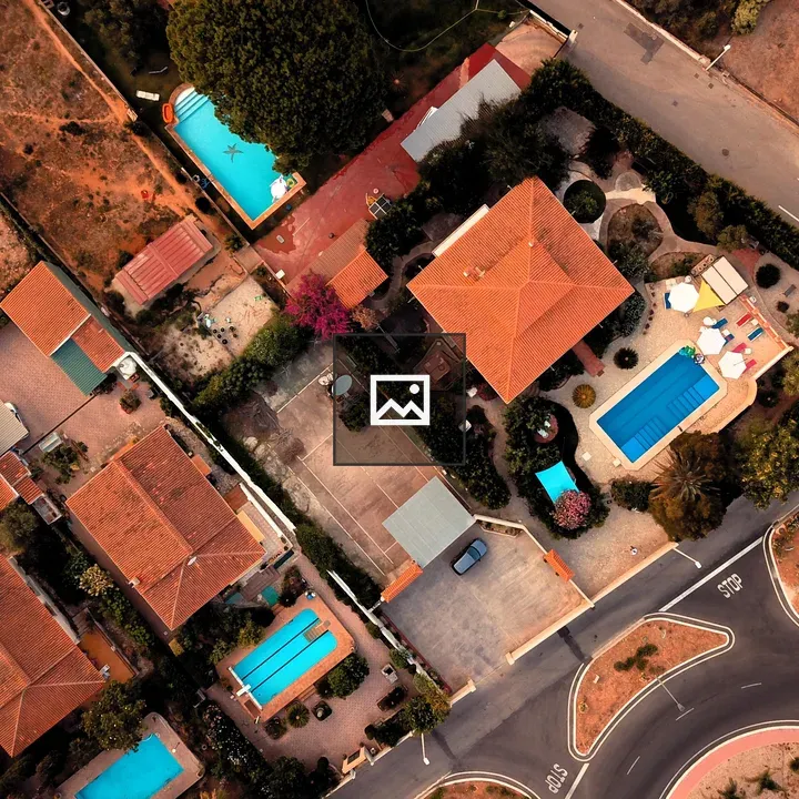 Aerial view of house with pools