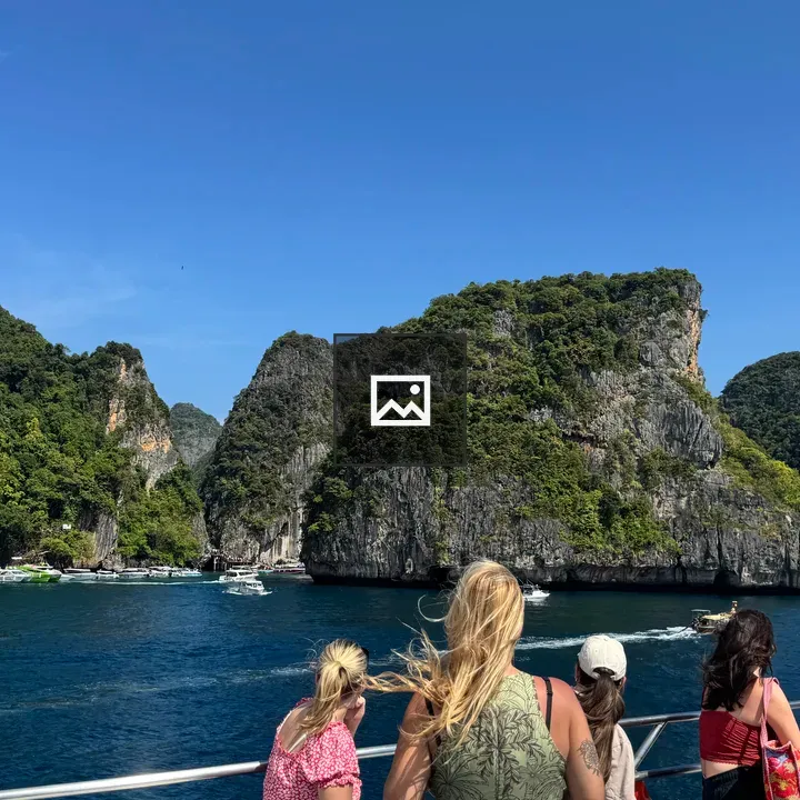 Passengers on a boat deck with turquoise cove