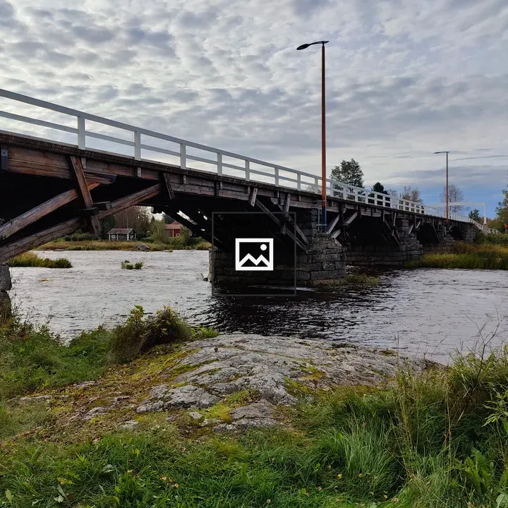 Rustic wooden bridge over river