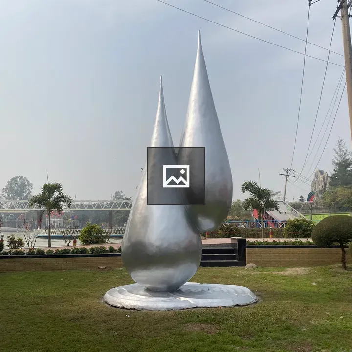 Silver teardrop sculpture on lawn