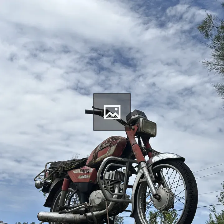 Vintage motorcycle on mossy platform