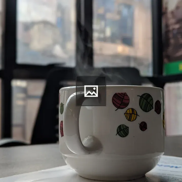Cup with vapour of hot beverage