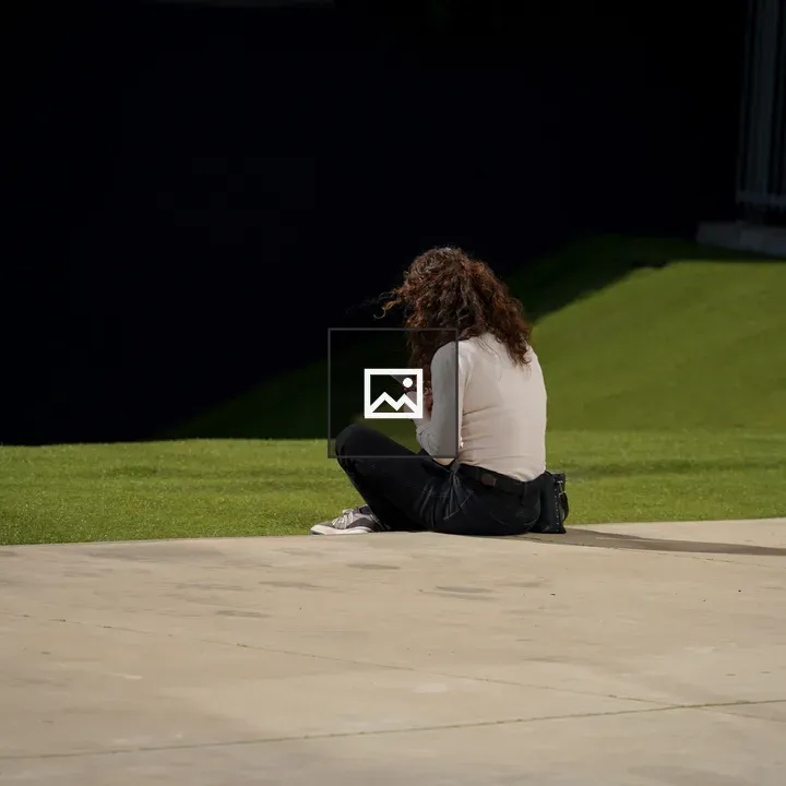 Person texting on grass