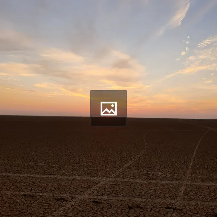 Sunset over blue desert sky