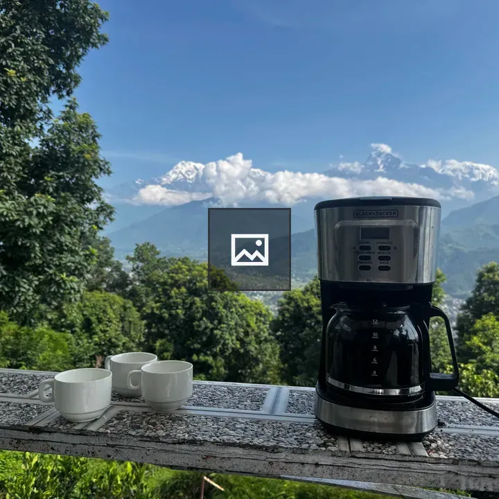 Coffee maker on tiled table outdoors