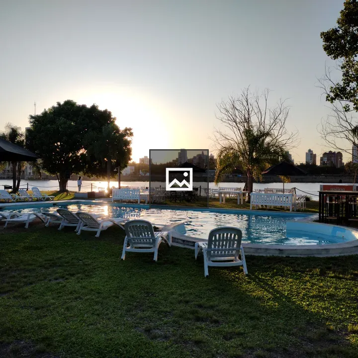 Pool by the River with White Chairs