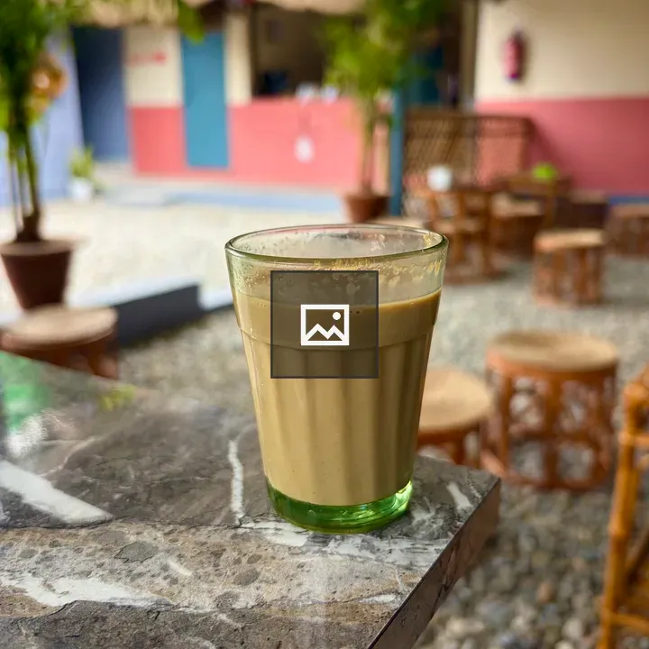 Glass of creamy chai on marble table