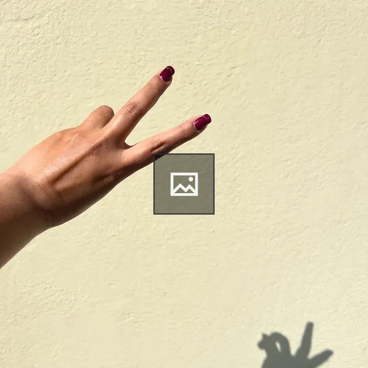 Peace sign hand with red nail polish