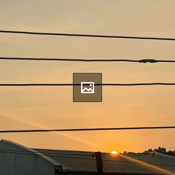 Sunset Over Rooftops and Powerlines