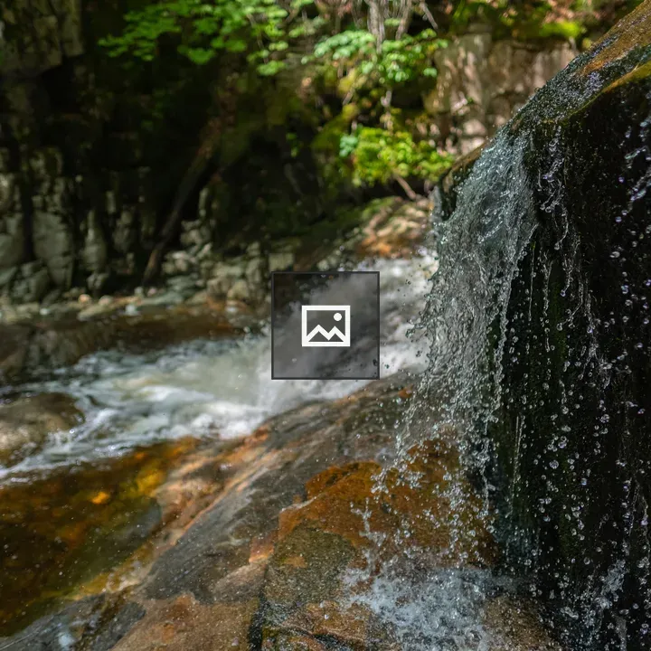 Waterfall over glacial rocks in White Mountains
