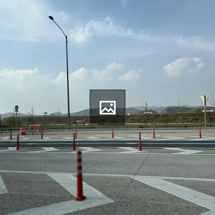 Road with traffic cones and hills