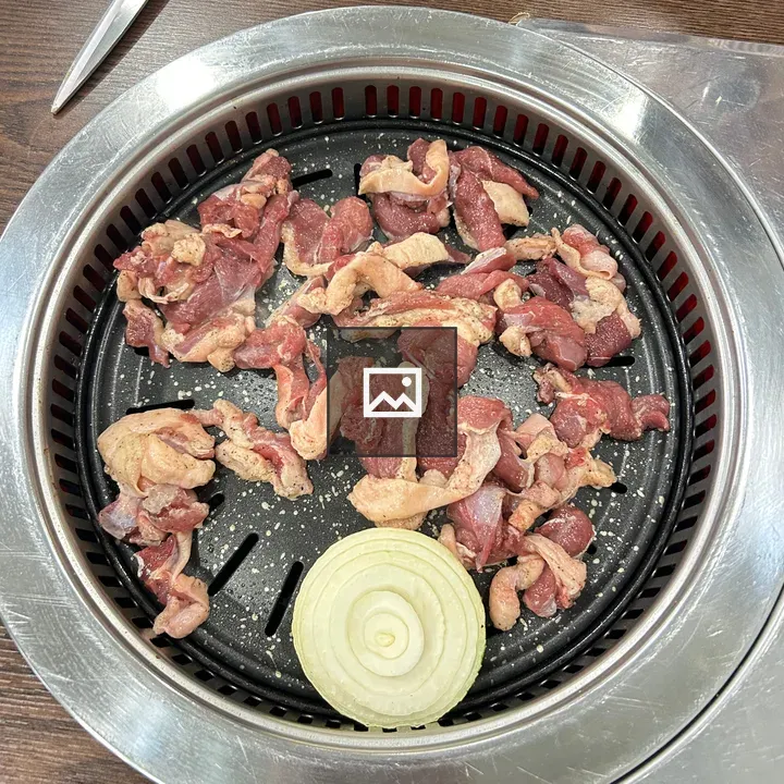 Raw sliced meat on grill