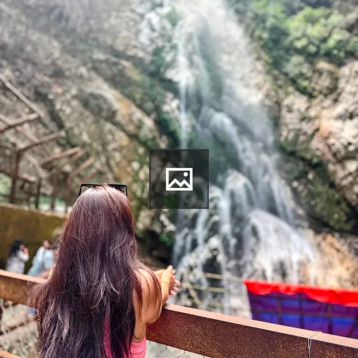 Back View of Person by Waterfall