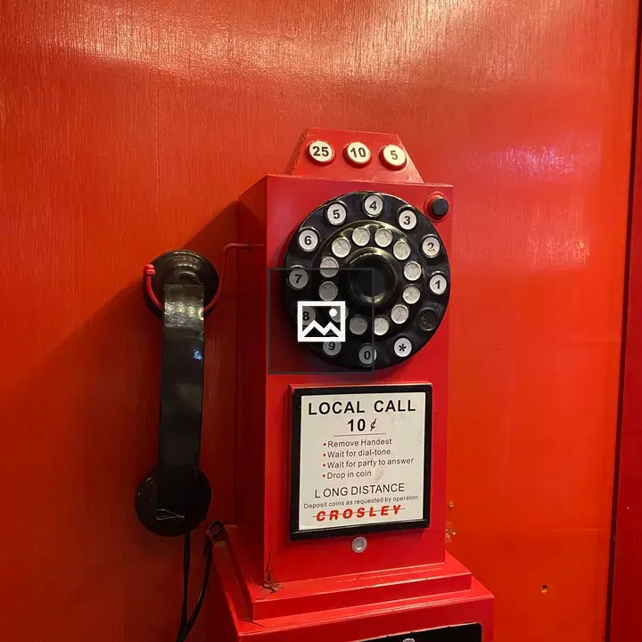 Vintage red rotary payphone