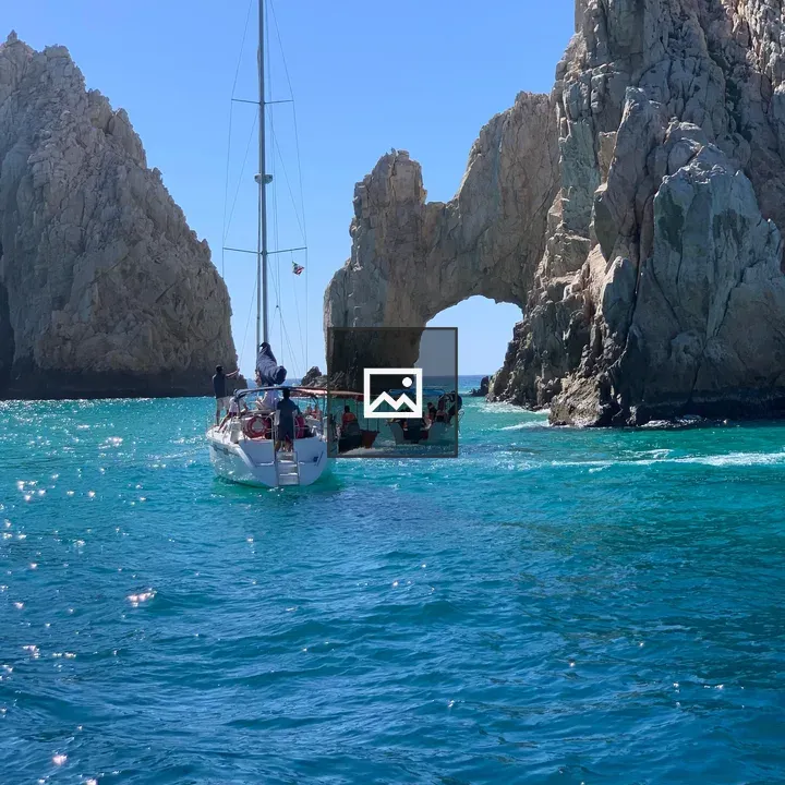 Boats Near Arch Rock in Turquoise Waters