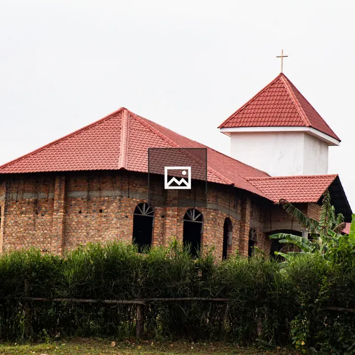 Brown brick church with red roof