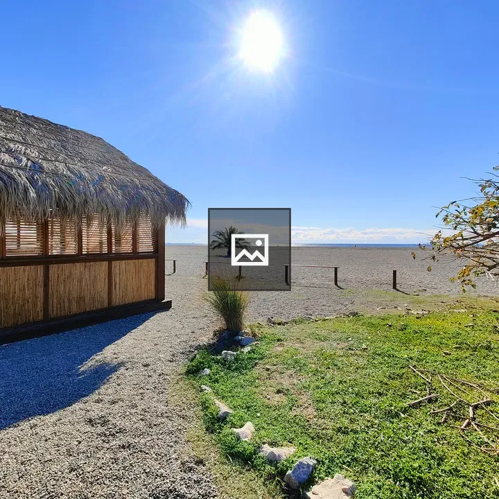 Thatched-roof Structure by Gravel Path