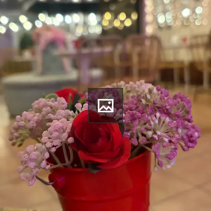 Red bucket with artificial flowers