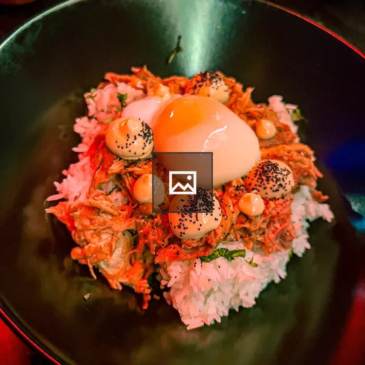 Rice dish with egg on black plate