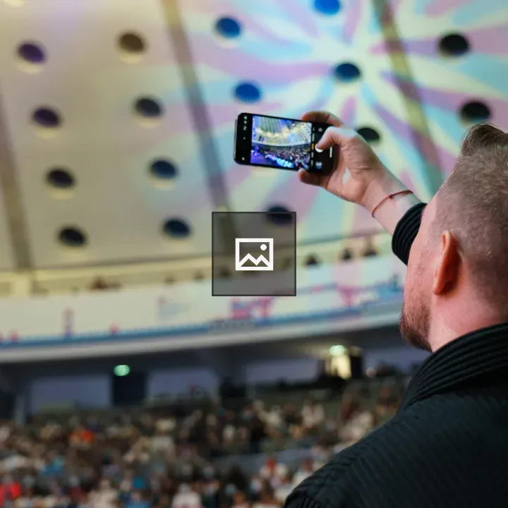 Man with Smartphone in Auditorium