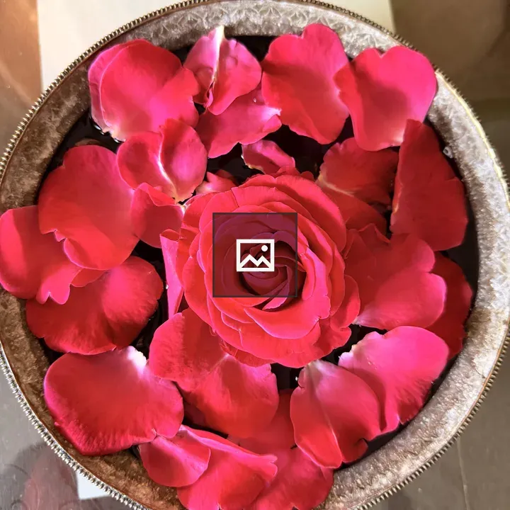 Round decorative container with rose petals