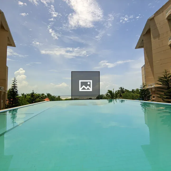Infinity pool by buildings and greenery