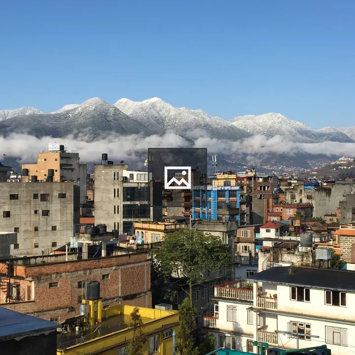 Snow-capped hills over Nepali terrace