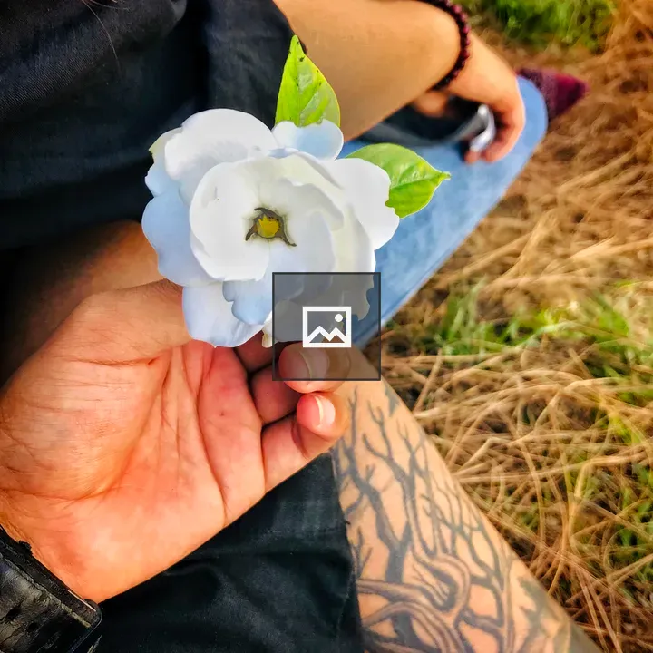 Hand Holding White Blossom