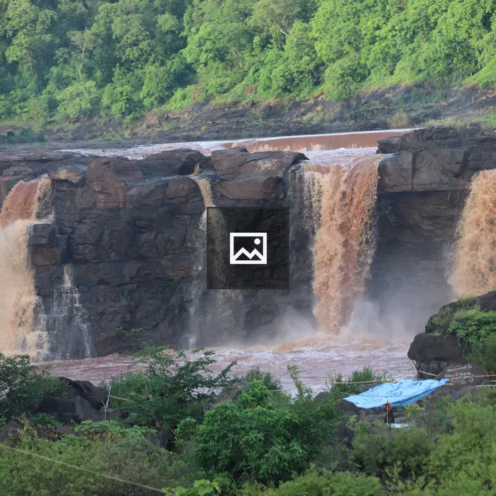 Waterfall with Brown Water in Nature