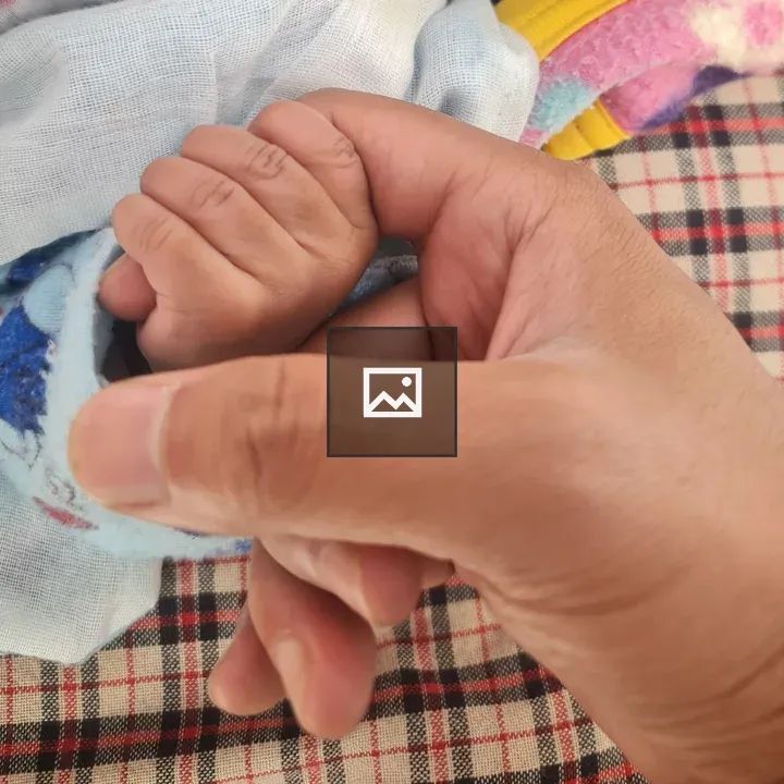 Infant Grasping an Adult Finger