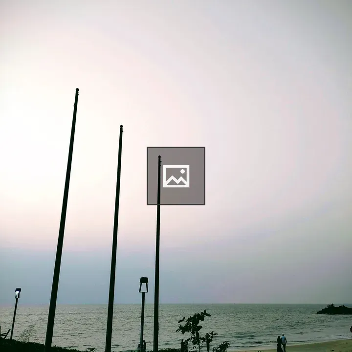 Empty flagpoles at shoreline