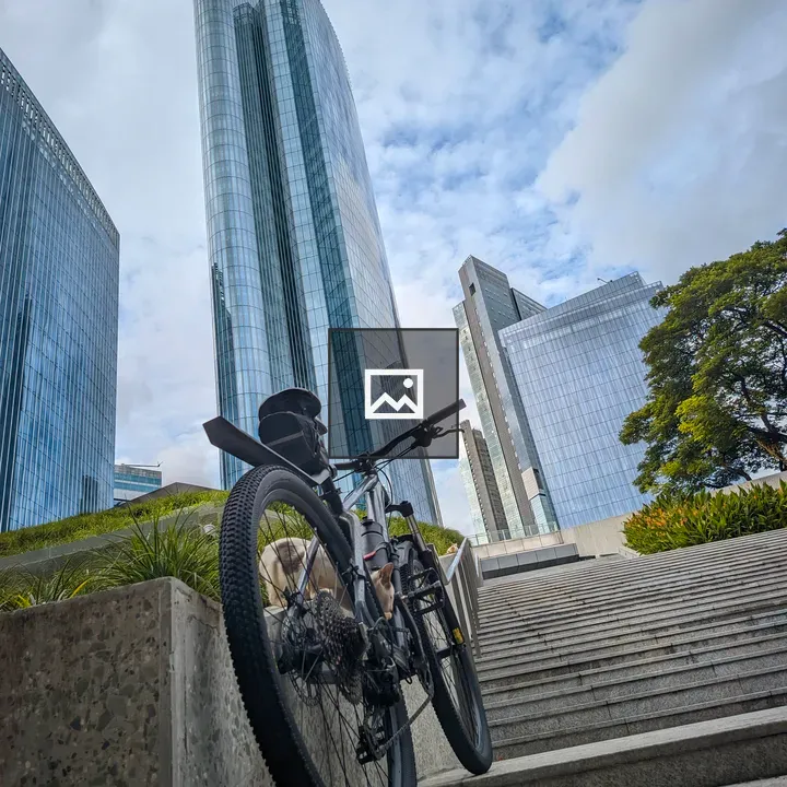 Mountain bike by stairs and skyscraper
