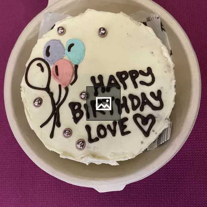 White-frosted cake in beige box