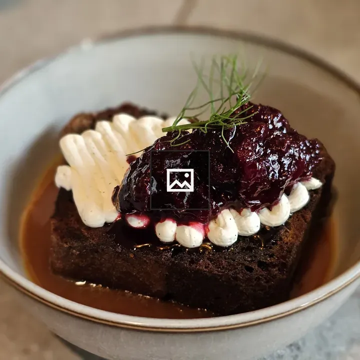 Banana cake with cherry jam and vanilla cream