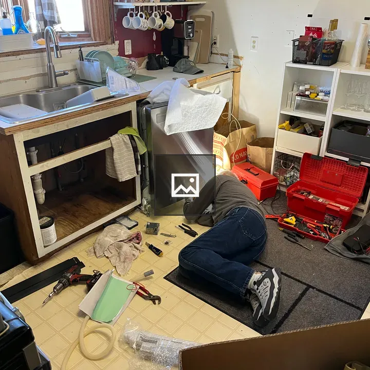 Man Installing Dishwasher on Kitchen Floor