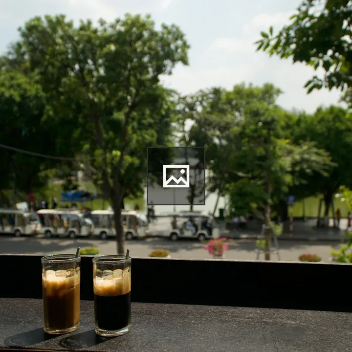 Two glasses of coffee at a cafe window