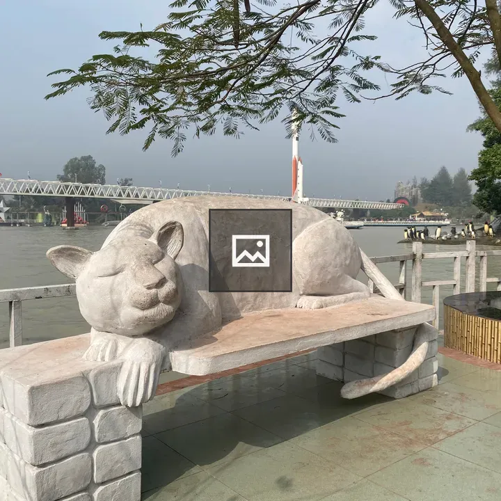 Large cat sculpture on bench