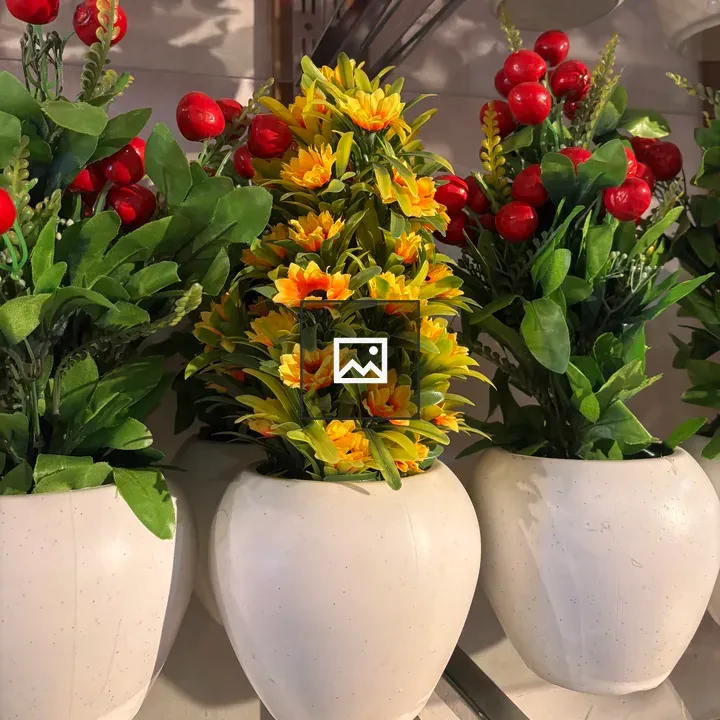 Three white pots with artificial flowers