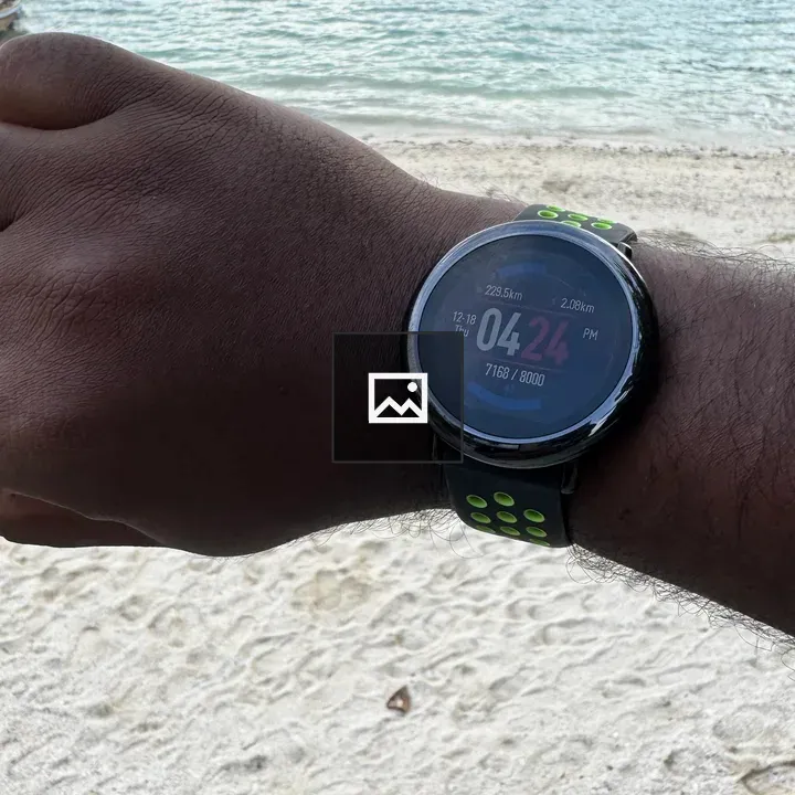 Wristwatch on wrist by beach