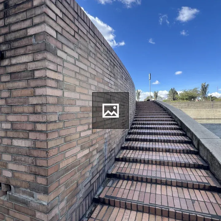 Flight of stairs against brick wall