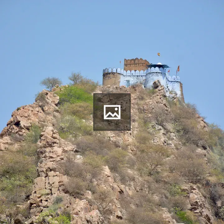 Hilltop temple fortress above rocky slopes