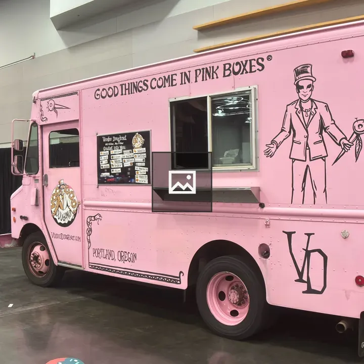 Pink food truck inside hall