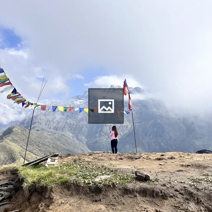 Female trekker with Nepal flag
