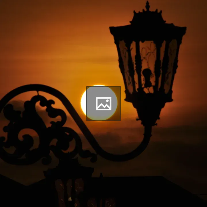 Silhouette of Ornate Streetlamp at Sunset
