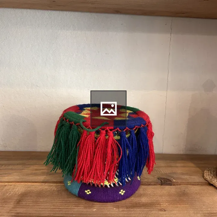 Round woven container with colorful patterns