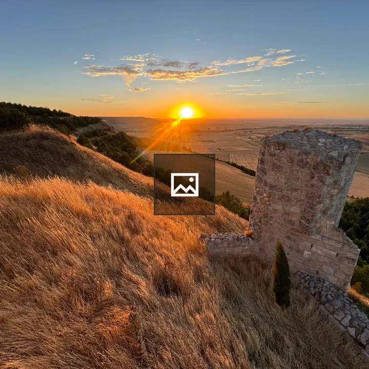 Stone tower over grassy ridge