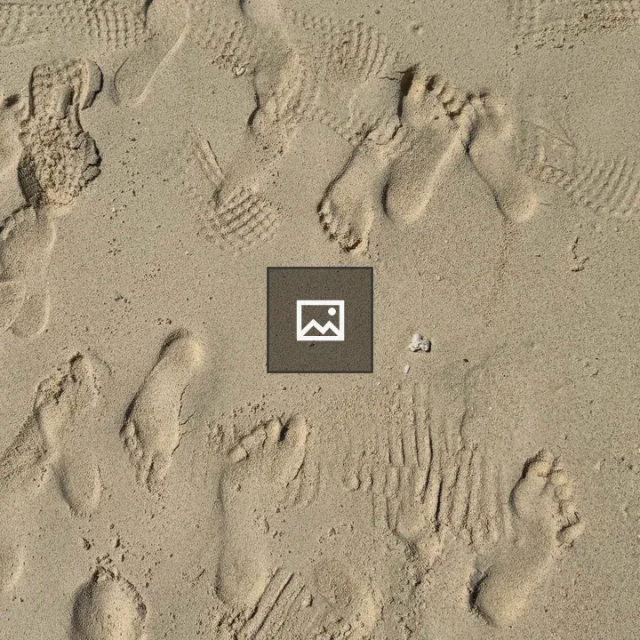 Footprints on Dry Beach Sand