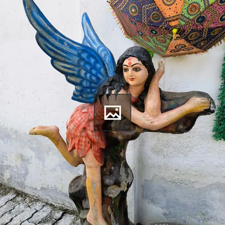 Sculpture of wings and umbrella