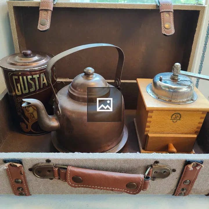 Vintage suitcase with copper teapot