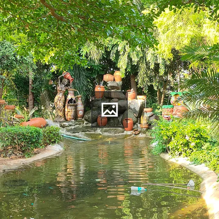 Garden pond with greenery and statue